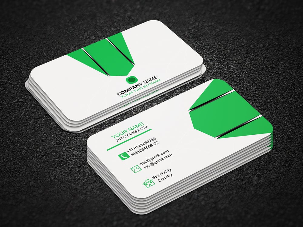 a green and white business card on a black surface