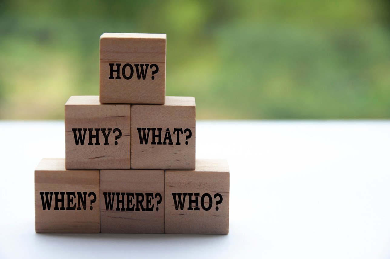 a stack of wooden blocks with the words how, why and where written on them